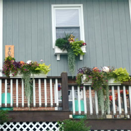 Window boxes and flower boxes on top of railings - back deck oasis