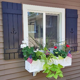 Wolfgang window box with our custom Board and Batten Shutters with Anchor Cutouts
