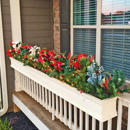 Christmas window boxes on front porch railings