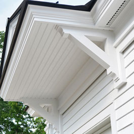 Large White Wooden Brackets Supporting Overhang Colonial