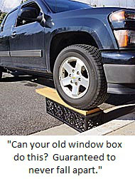 Truck driving on top of wrought iron window box