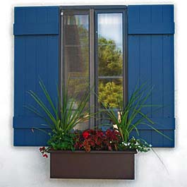 brown window box with blue shutters