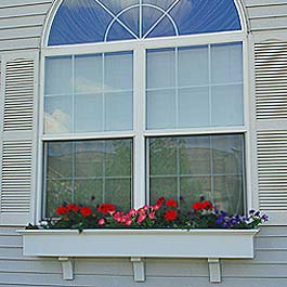 large double hung sunburst window with flower box