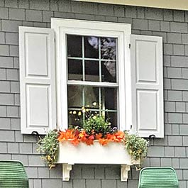 Grey Exterior Shutters and Flower Box on Cedar Shake Siding