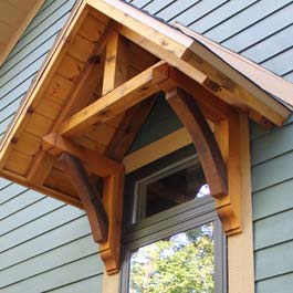 cedar portico over window with cedar brackets and gable