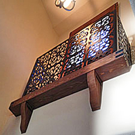 large cedar corbels under ornamental window balcony