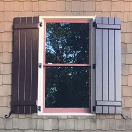 pvc composite board and batten shutters in brown on cedar shake siding