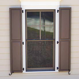 tall brown raised panel shutters on three hinges