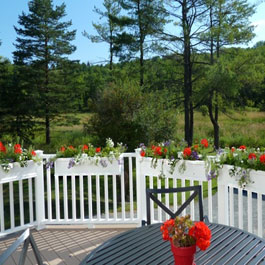 flower boxes and planters on curved deck railings