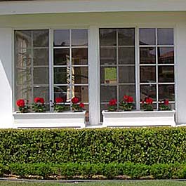 two planters sitting on window ledge
