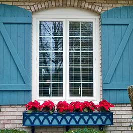 blue decorative window box with z batten shutters