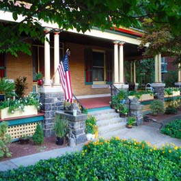 front porch yellow planters between japanese style columns