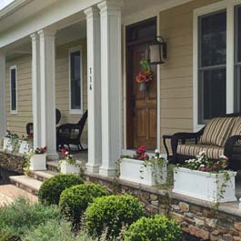 freestanding porch planters between front porch posts