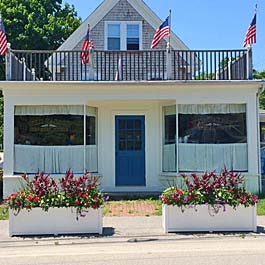 two large rectangular curb side planters in front of business