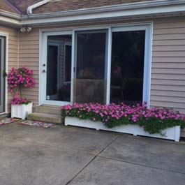 Long patio planters in front of sliding glass door